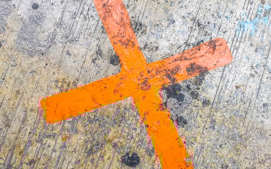 Orange painted cross on the sidewalk Playa del Carmen Mexico. photo