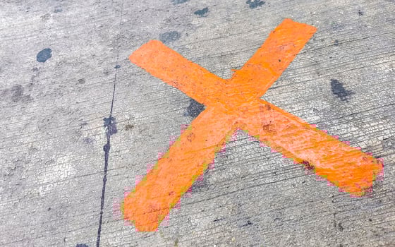 Orange painted cross on the sidewalk Playa del Carmen Mexico. photo