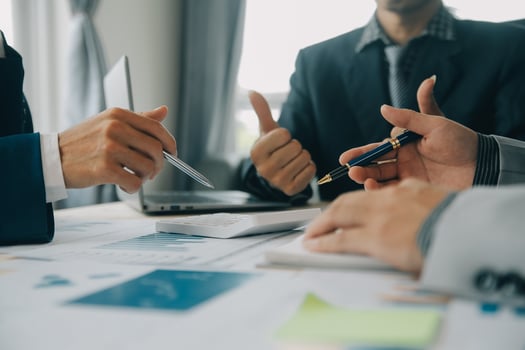 Financial analysts analyze business financial reports on a digital tablet planning investment project during a discussion at a meeting of corporate showing the results of their successful teamwork. photo