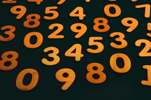 Wooden numbers on a black background. Numbers of different colors. photo
