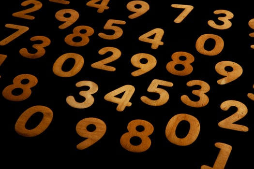 Wooden numbers on a black background. Numbers of different colors. photo