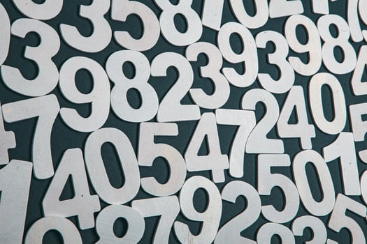 Wooden numbers on a black background. Numbers of different colors. photo