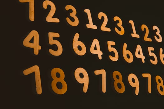 Colorful wooden numbers on a blackboard background with space for text photo