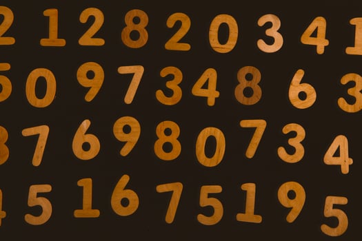 Wooden numbers on a black background. Numbers from zero to nine. photo