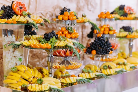Fruit bar. Table with fruits, bananas, grapes. orange and pineapple. Beautiful table setting, fruit on stands, selective focus photo