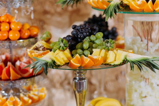 Fruit bar. Table with fruits, bananas, grapes. orange and pineapple. Beautiful table setting, fruit on stands, selective focus photo