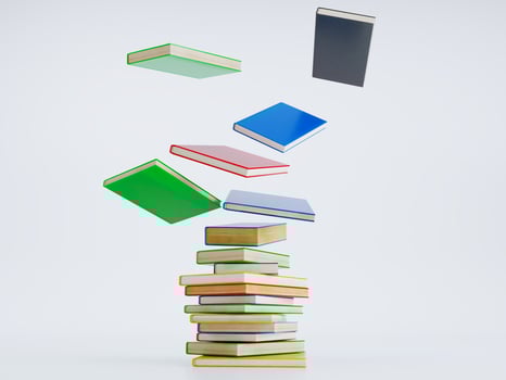 Colorful hardcover books flying on white background, photo