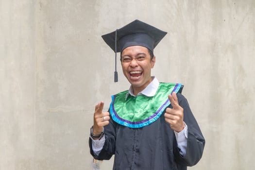 Young Indonesian guys celebration and cheers when graduation moment. photo