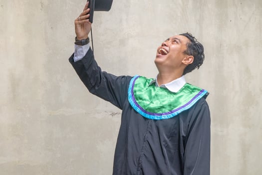 Young Indonesian guys celebration and cheers when graduation moment. photo