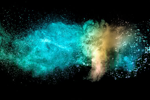 Abstract multicolored powder explosion on black background. Red and blue dust particles splattered on background. photo