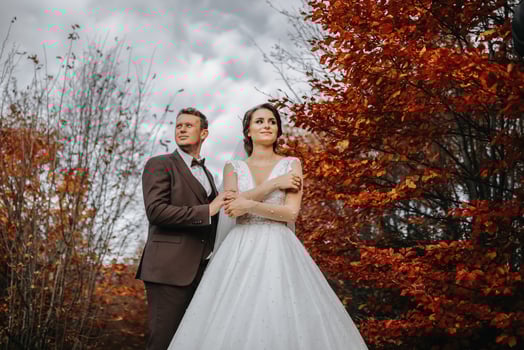 Wedding couple on a walk in the autumn park, medium portrait, place for text photo