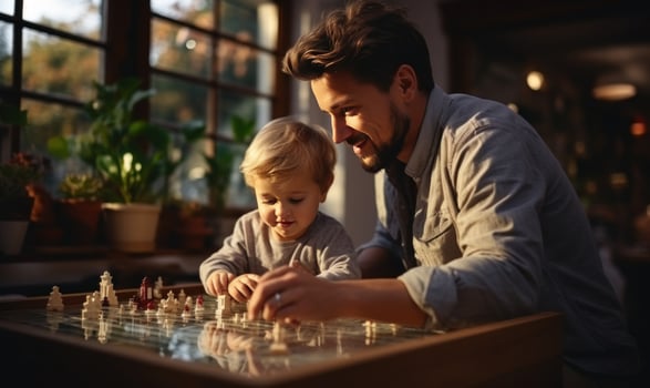 AI generated happy family man with his son playing on the table photo