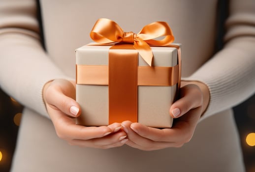 AI generated a womans hand holds the gift box with a ribbon photo