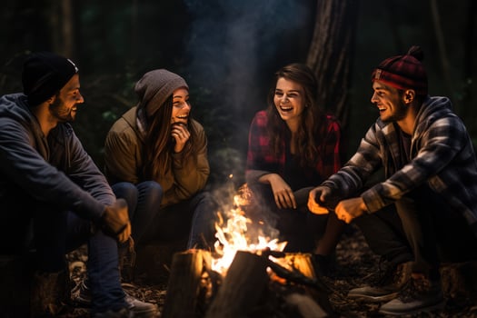 AI generated Group of young friends sitting near bonfire at night Camping concept, Young people sitting around a bonfire Ai generated photo