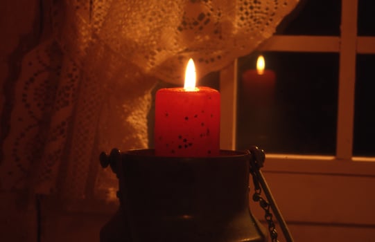 a candle is lit in a lantern photo