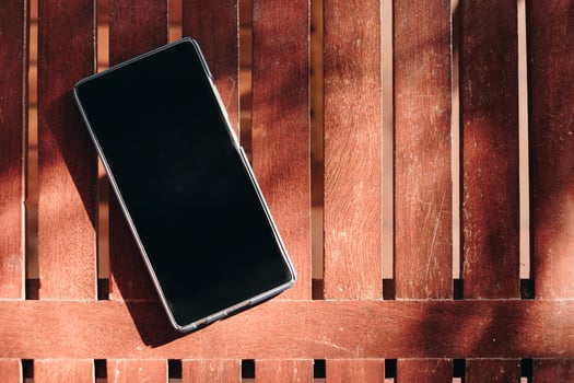 Smartphone blank display put on wooden table photo