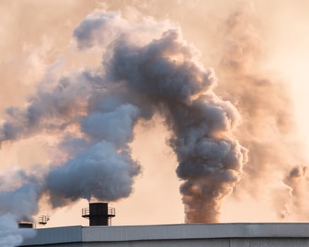 Factory burning cane with smoke and pollution on sky, global warming photo