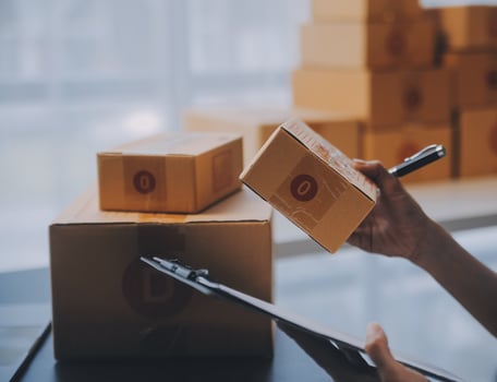 Startup small business entrepreneur or freelance Asian woman using a laptop with box, Young success Asian woman with her hand lift up, online marketing packaging box and delivery, SME concept. photo