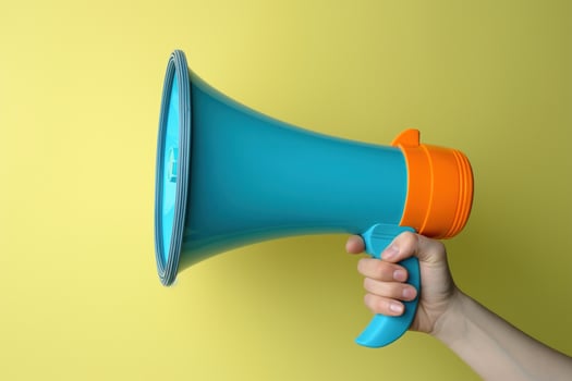 AI generated A hand holding a megaphone against a yellow background photo
