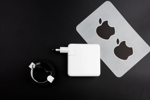 Bangkok, Thailand - December 27, 2023 Apple fanboy unboxing latest new MacBook Pro M3 with stickers, power adapter and black braided USB-C cable photo