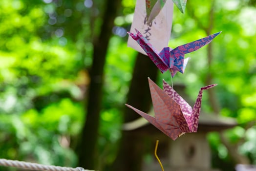 A paper crane swaying in the wind at the traditional street close up photo