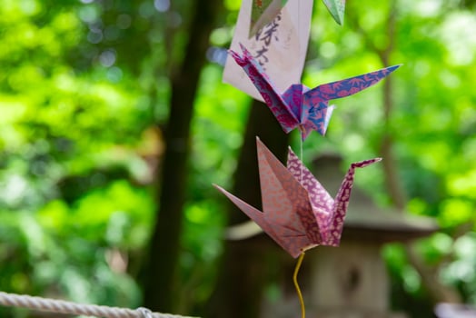 A paper crane swaying in the wind at the traditional street close up photo
