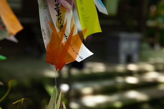 A paper crane swaying in the wind at the traditional street close up photo