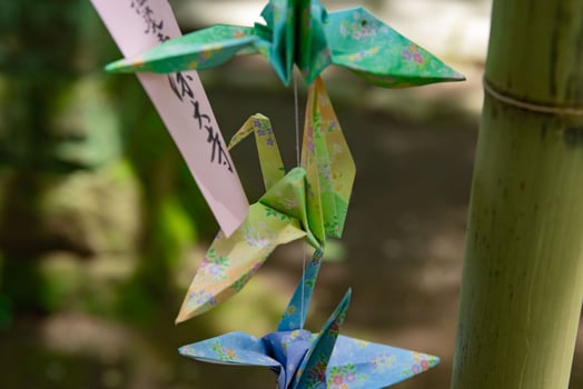A paper crane swaying in the wind at the traditional street close up photo