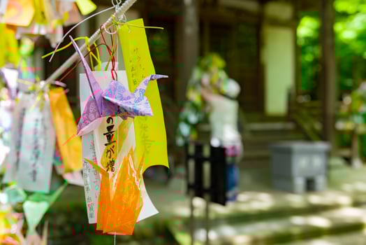 A paper crane swaying in the wind at the traditional street close up photo