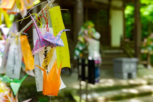 A paper crane swaying in the wind at the traditional street close up photo