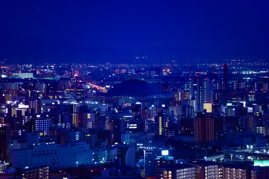 A dusk cityscape by high angle view near Kyocera dome in Osaka telephoto shot photo