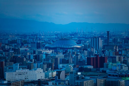 A dusk cityscape by high angle view near Kyocera dome in Osaka telephoto shot photo