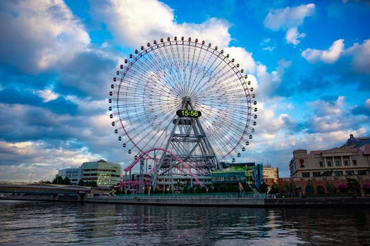 A ferris wheel at the urban city in Yokohama wide shot photo