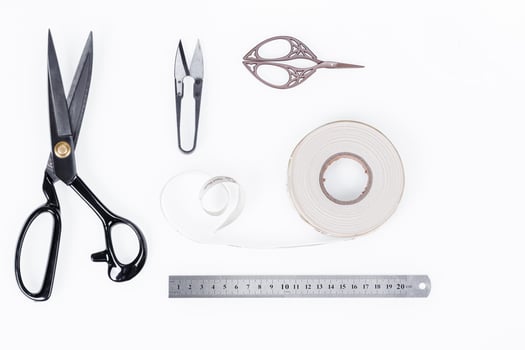 set of ruler, chalk, sticky tape, scissors for sewing on white background photo