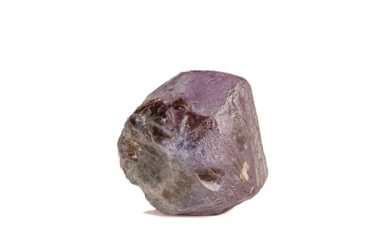 macro mineral stone alexandrite red - violet in daylight on a white photo