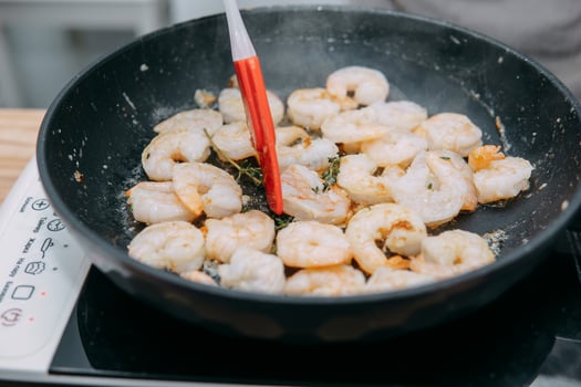 Preparing Sarsuella in a cooking mater class. Shrimp close-up. home-cooked food. prawns in a pan photo