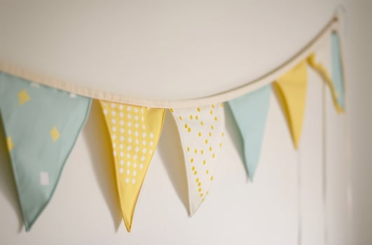 AI generated the bunting is hanging from a white wall against a white wall photo