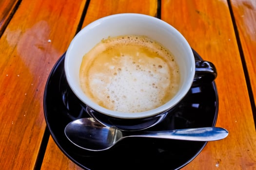 close up view of a cup of cappuccino coffee photo