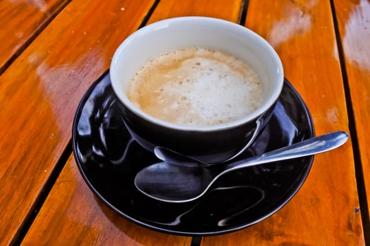 close up view of a cup of cappuccino coffee photo