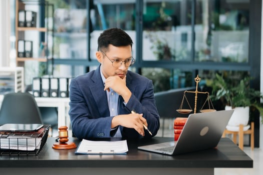 Attractive young lawyer in office Business man and lawyers discussing contract papers laptop and tablet with brass scale on  desk i photo