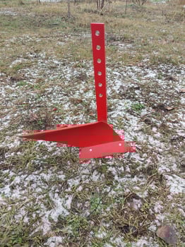 Red mini plow on a winter field photo