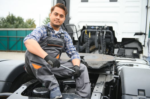Man in uniform. Truck repair. Car malfunction. photo