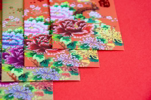 Chinese New Year decoration with colorful packets on red cover background photo