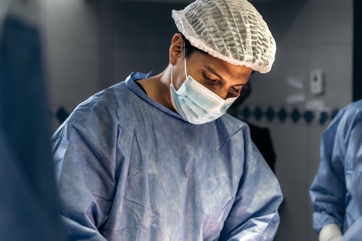 A skilled male surgeon performing a meticulous scoliosis surgery in a medical facility photo