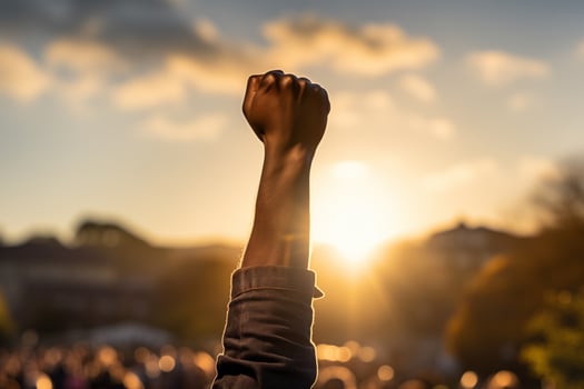 AI generated a black man's fist is raised up against the sky. black history month photo