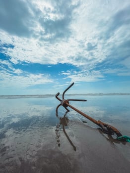 BEACH SEA-WAVE SAND AND WHITE SANDS OF A RUSSY ANCHOR photo