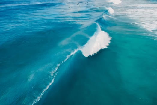 Blue wave in tropical ocean. Breaking barrel wave. Aerial view photo