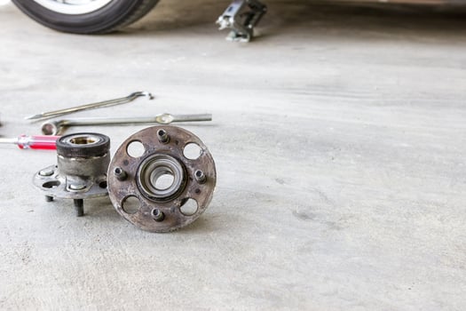 Wheel bearing and tool on the cement floor in service shop photo