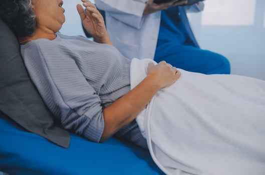 Female doctor administers specialized medical treatment to a patient in a hospital room. The procedure includes fluid therapy and injections to support the patient's health diagnosis and recovery. photo
