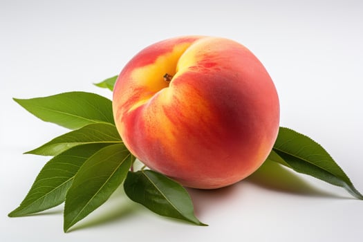 a peach with leaves on a white background photo